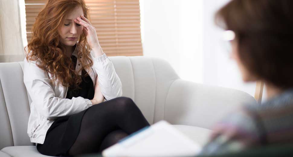woman in psychotherapy, talking to her therapist about her problems